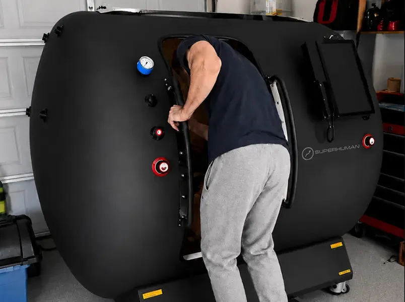 Clinician operating a Superhuman hyperbaric chamber control panel