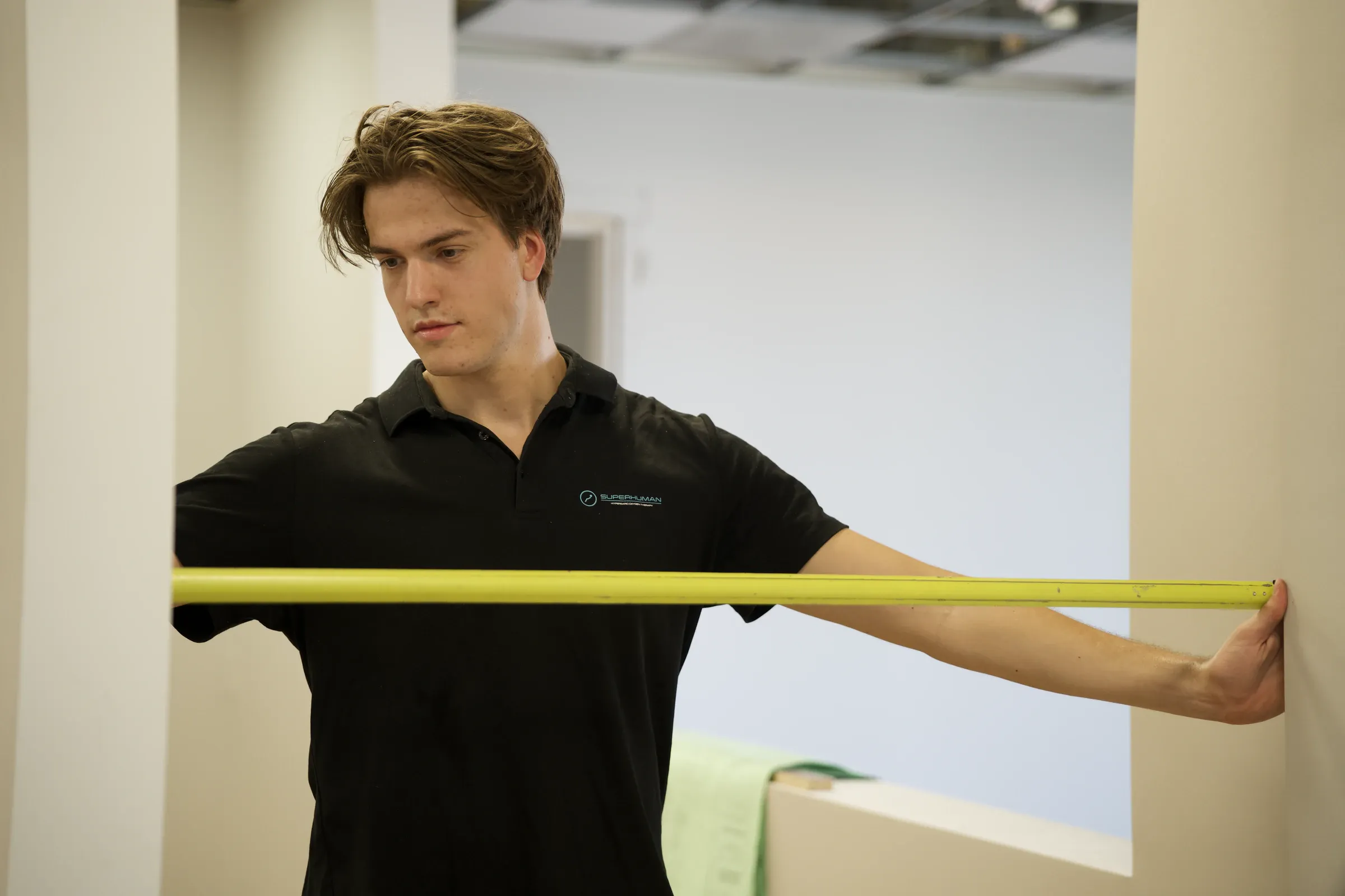 A Superhuman specialist stretching a tape measure across a doorway during a site survey
