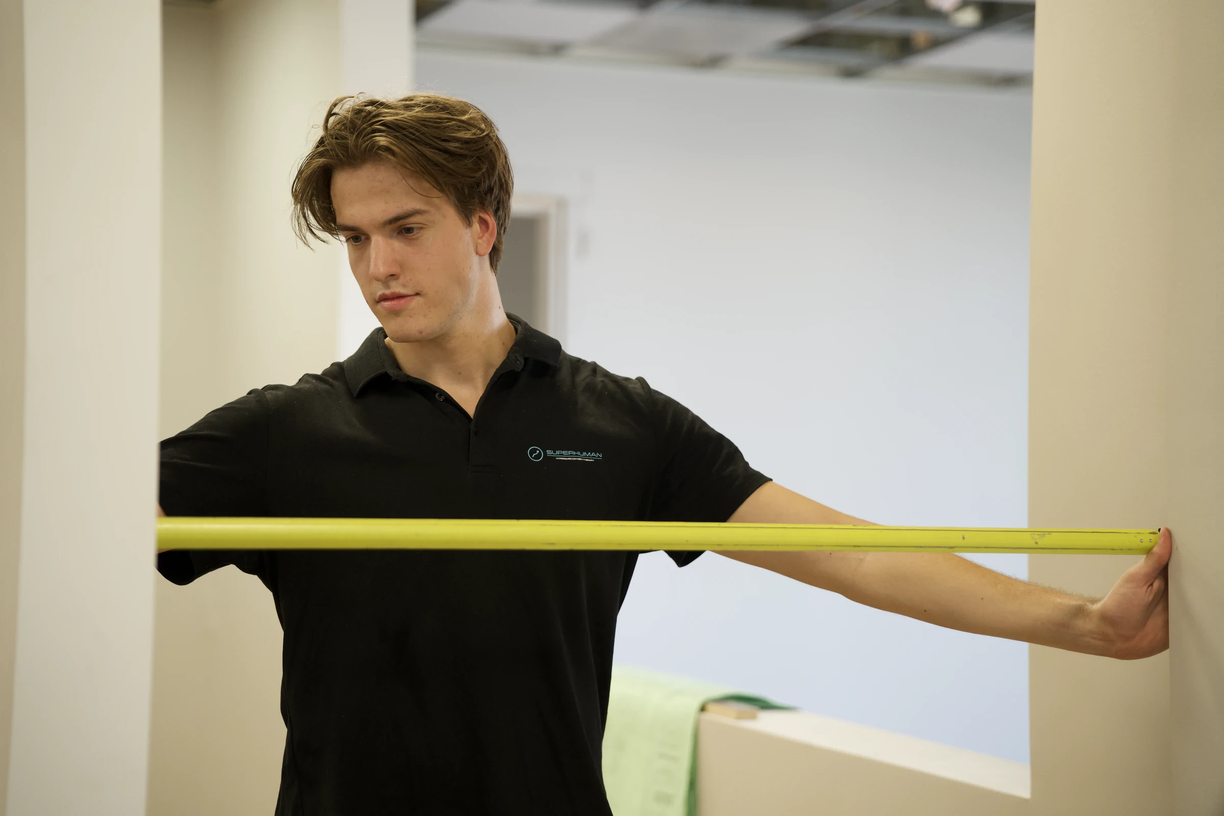 A Superhuman specialist stretching a tape measure across a doorway during a site survey