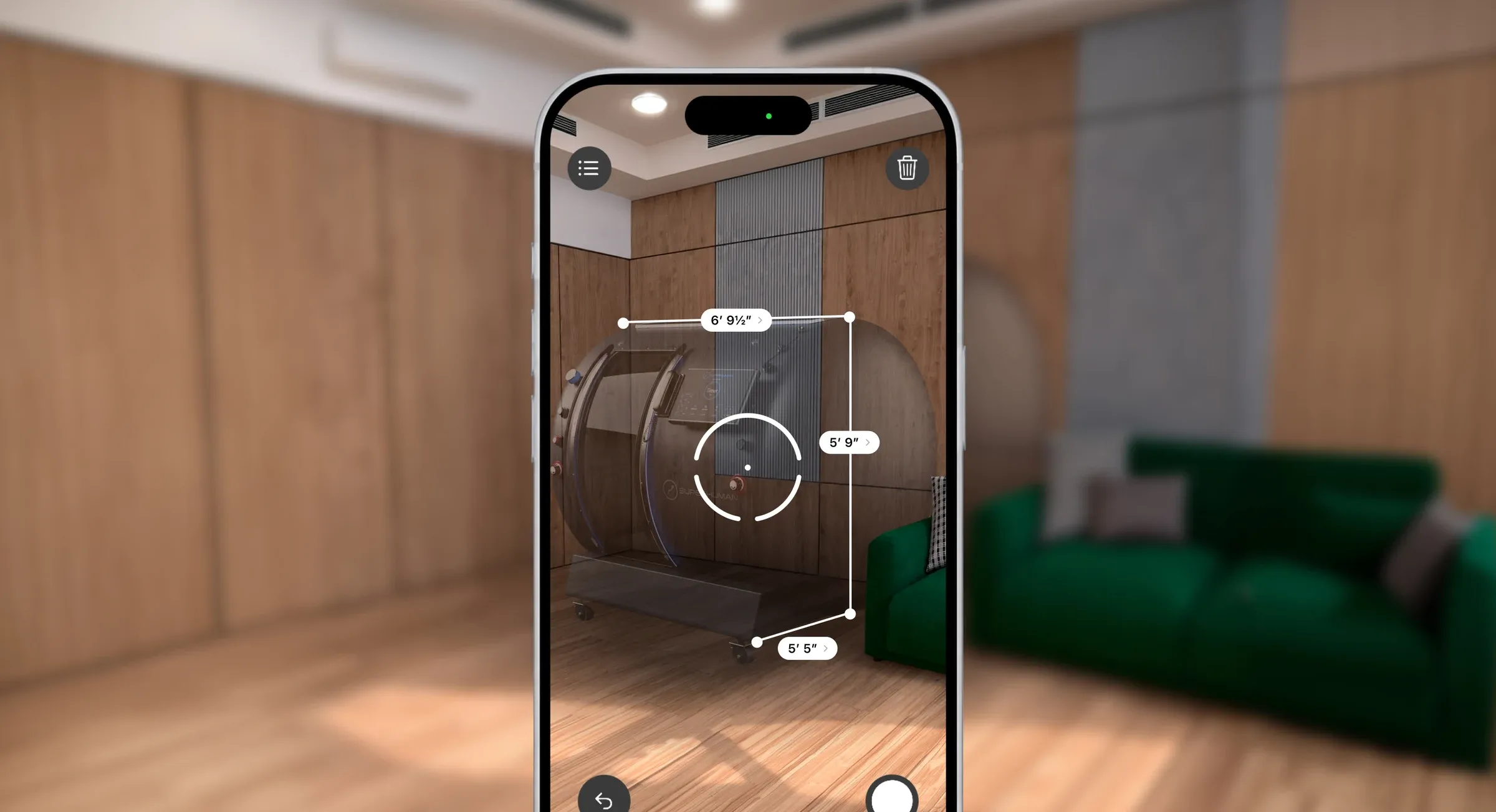 A phone measuring the T2 in a room in augmented reality, its length, width and height marked