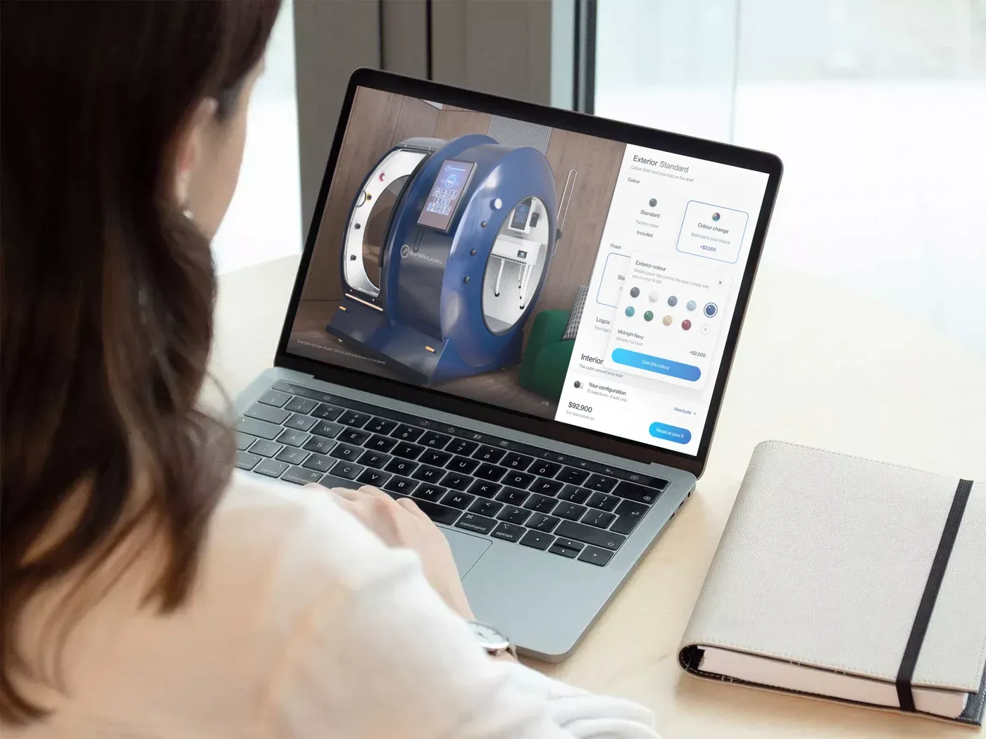 A person at a laptop with the X configurator open, a blue chamber on screen