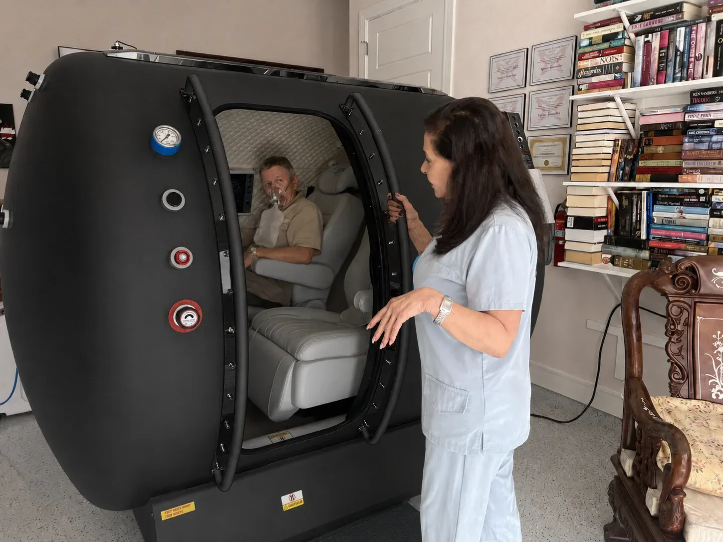 Technician helping a client into the T2 chamber