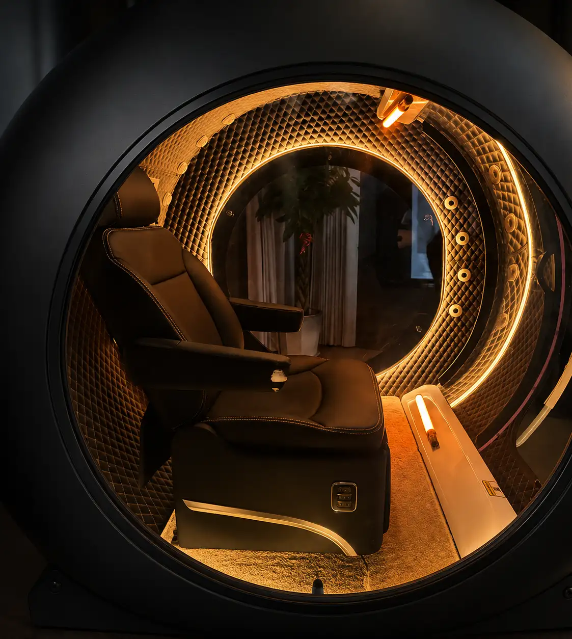 Reclined leather seat inside the Superhuman X under warm ring lighting